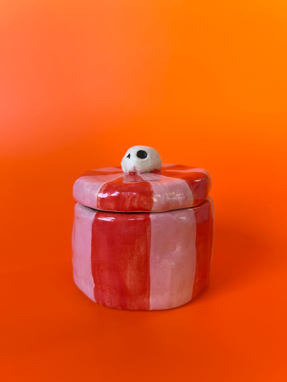 Tiny ceramic jar with a skull knob