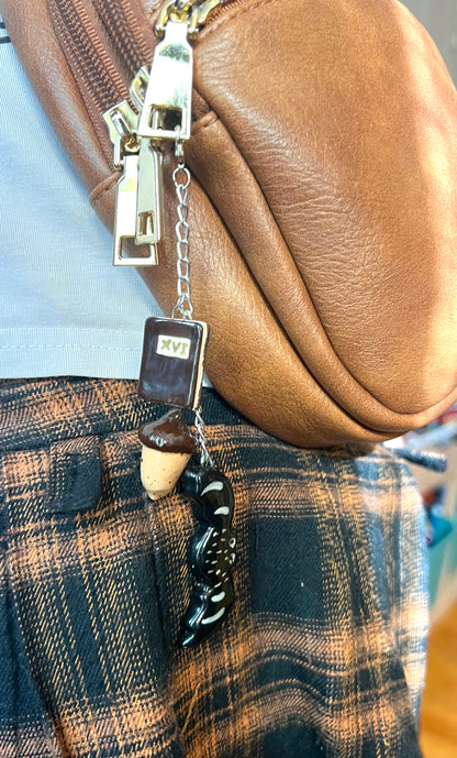 Autumn ceramic bag charm with book, bat, and acorn