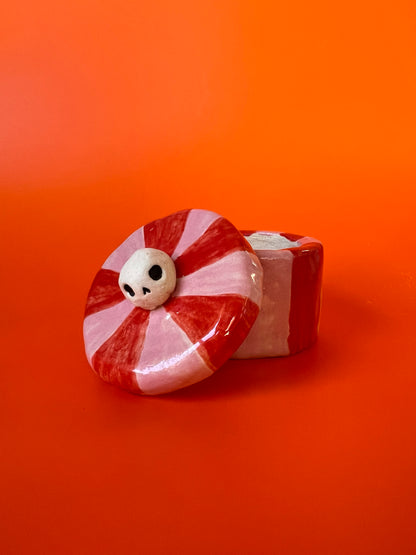 Tiny ceramic jar with a skull knob
