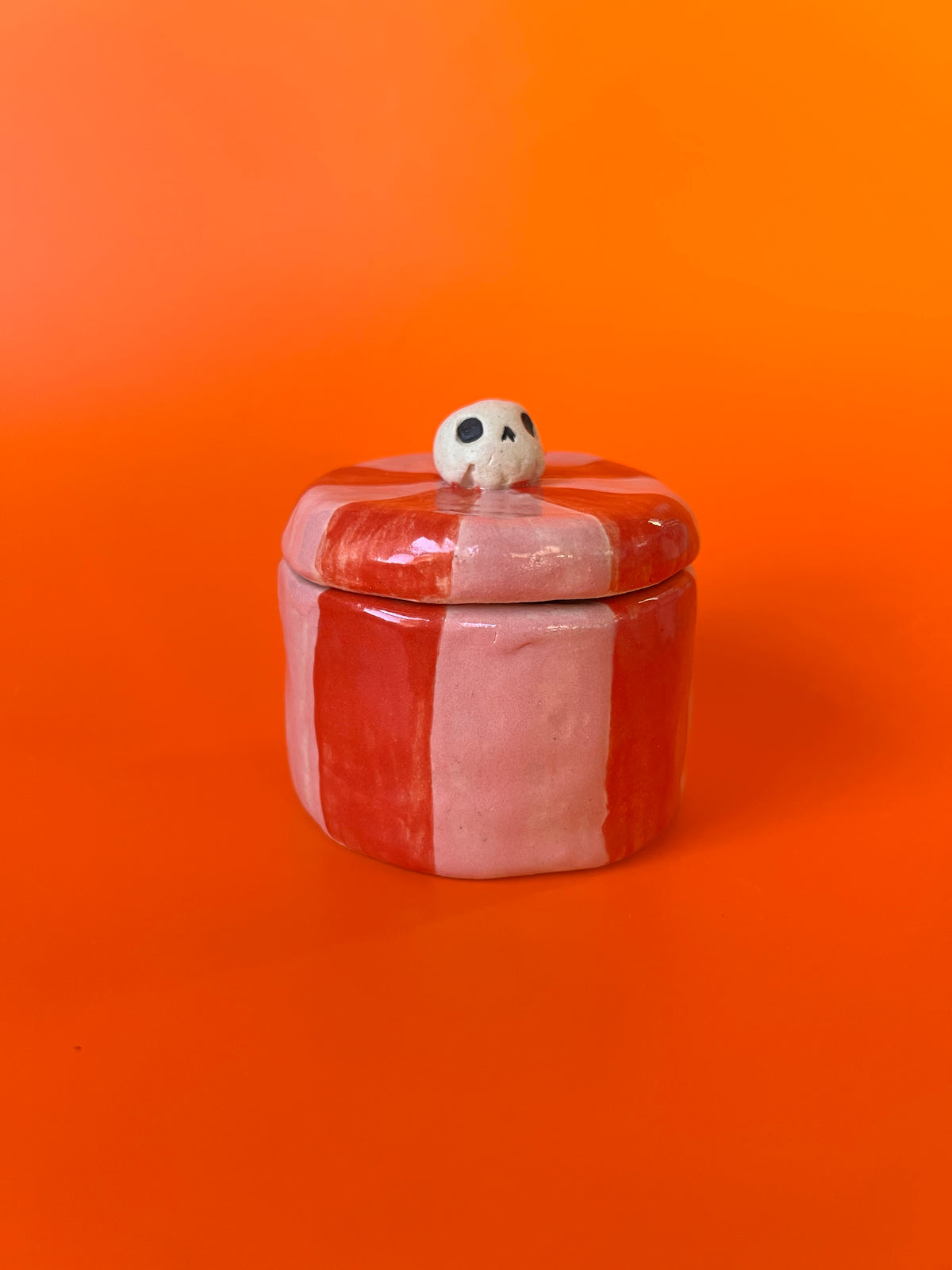 Tiny ceramic jar with a skull knob