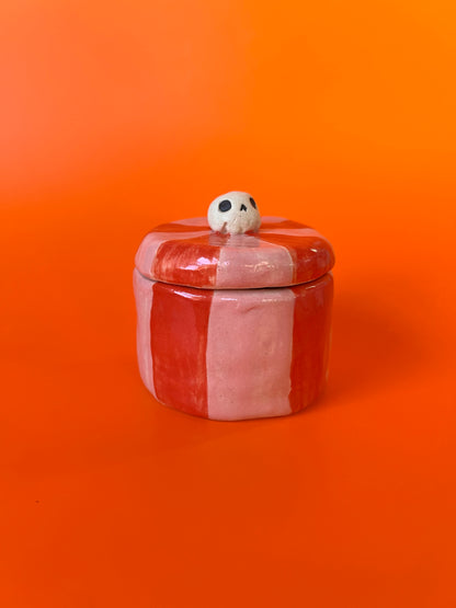 Tiny ceramic jar with a skull knob