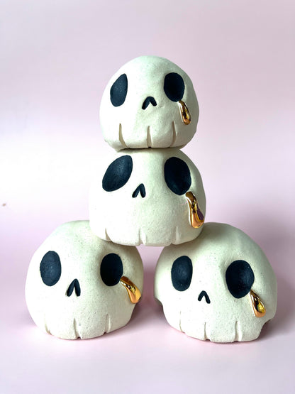 Ceramic skull crying a single tear of gold