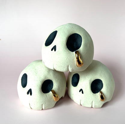 Ceramic skull crying a single tear of gold