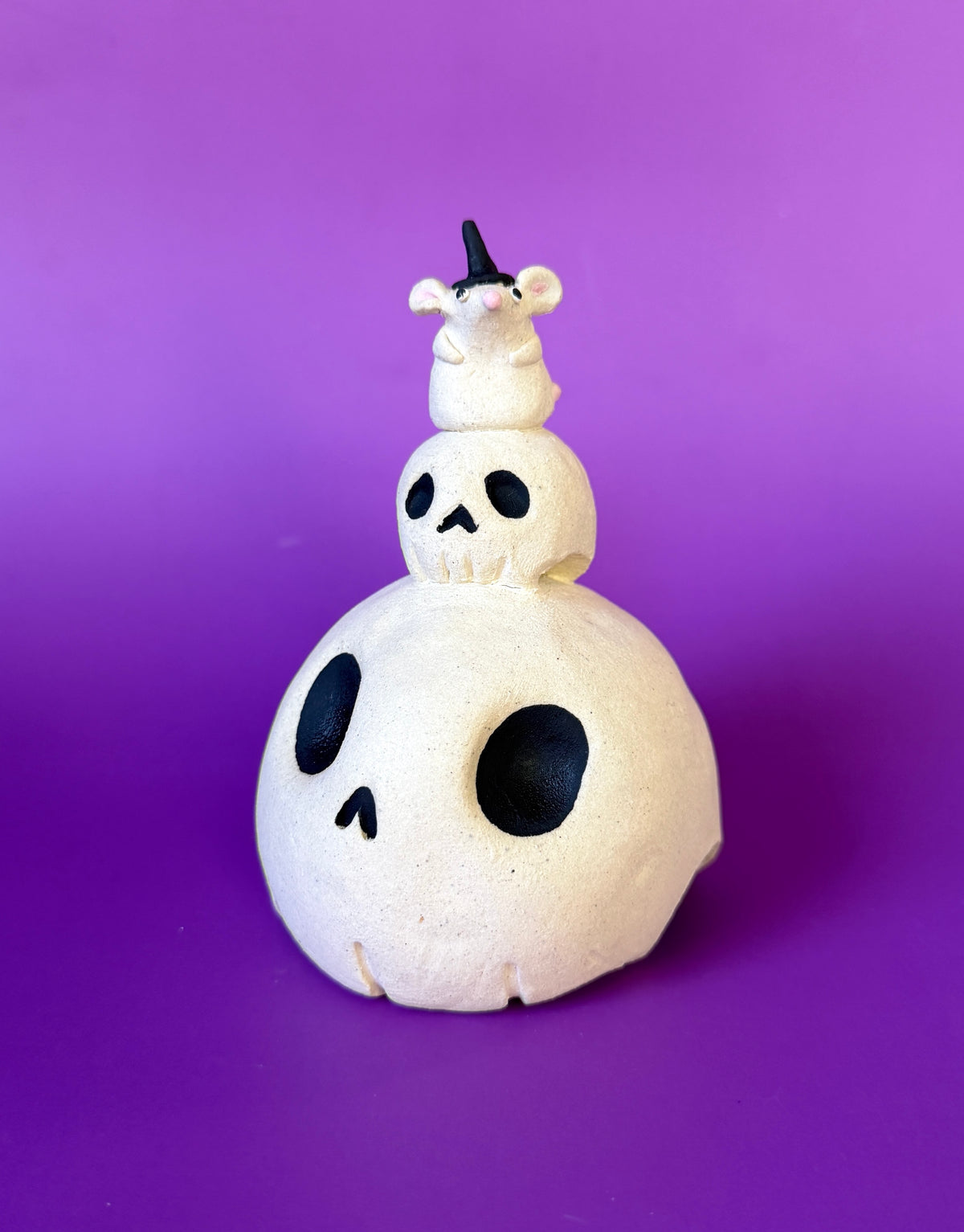 Ceramic Skull Bust with a tinier skull on top and an even tinier mouse on top of that