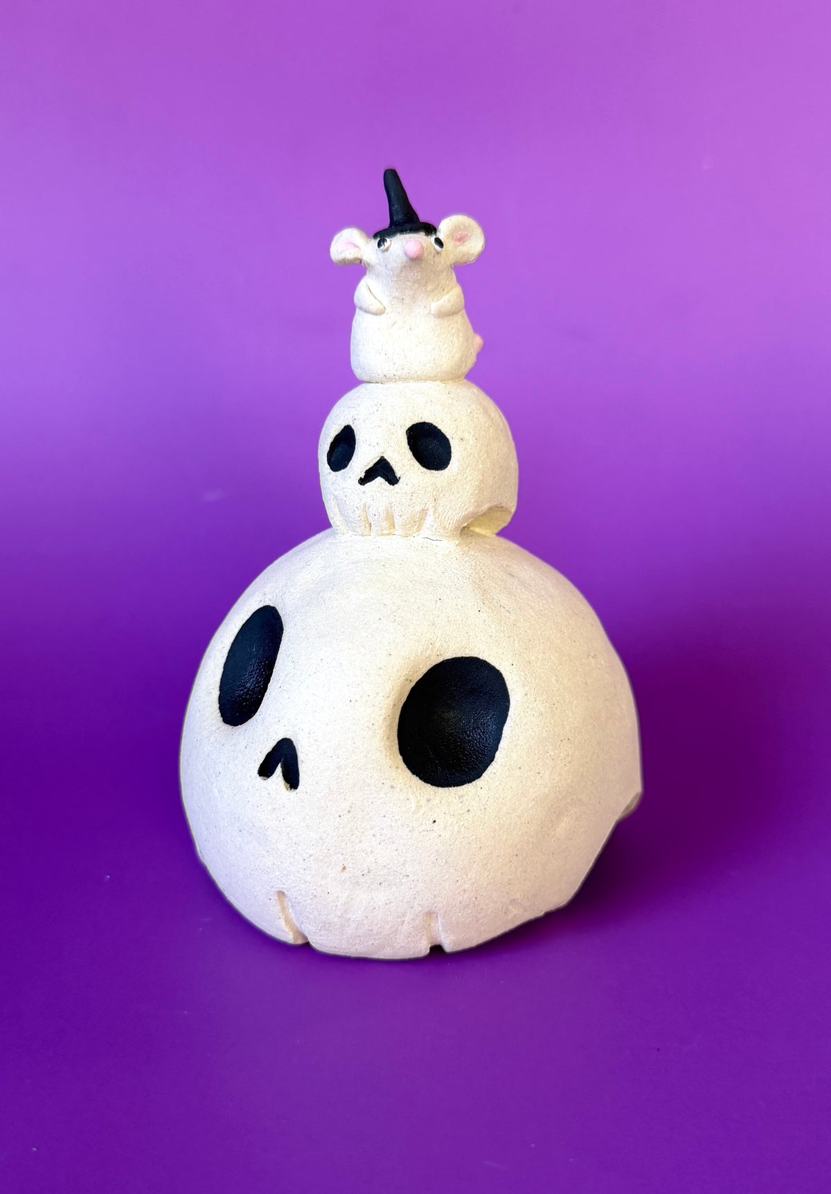 Ceramic Skull Bust with a tinier skull on top and an even tinier mouse on top of that