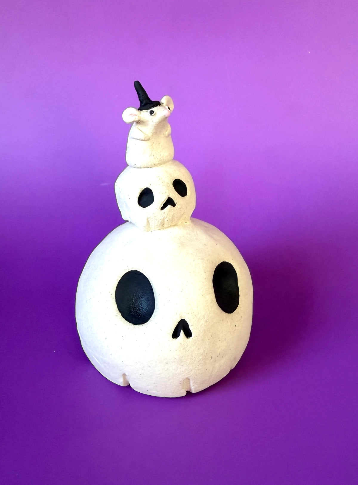Ceramic Skull Bust with a tinier skull on top and an even tinier mouse on top of that