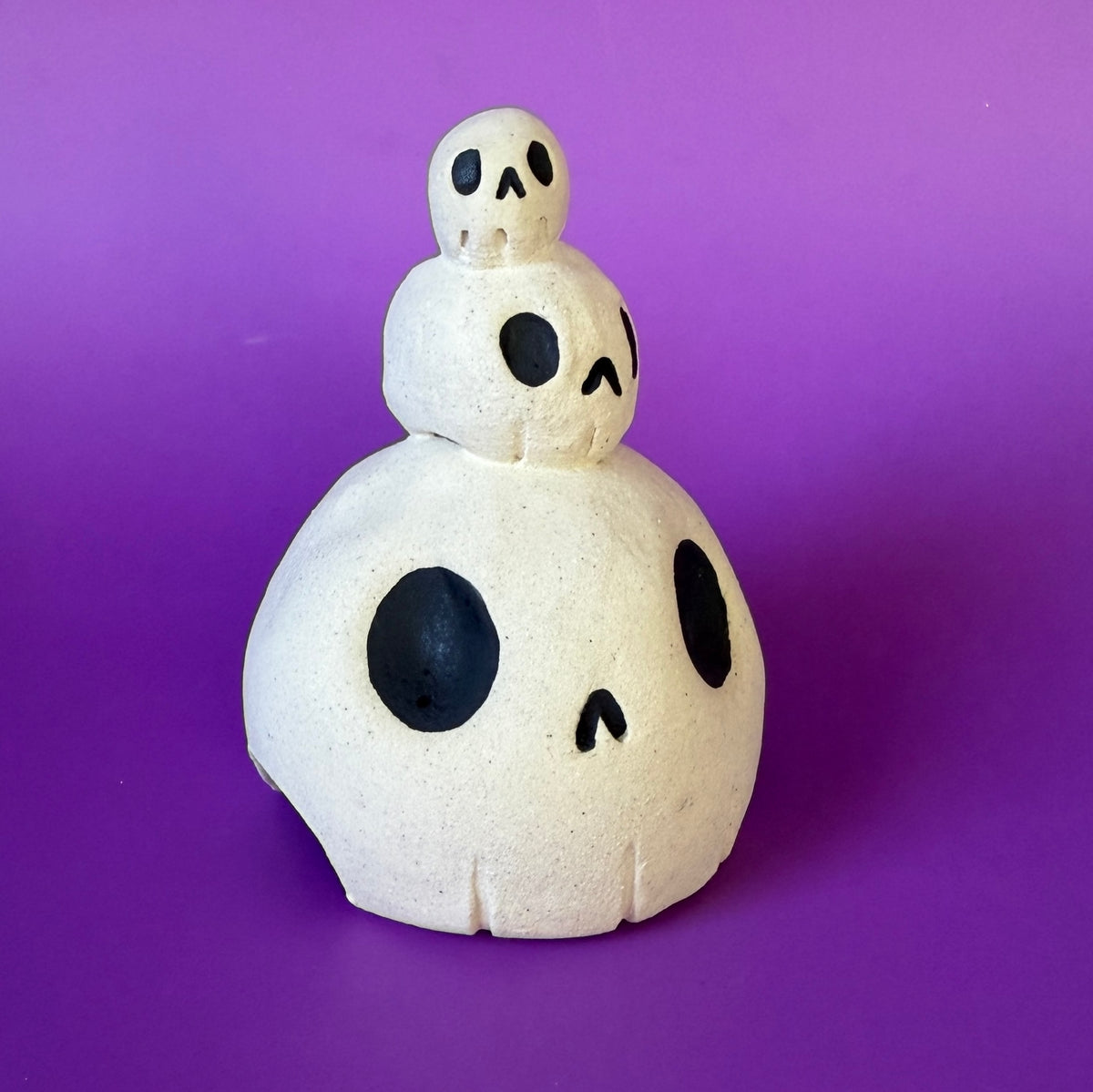 Three skulls stacked on top of each other ceramic bust